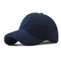 Close-up detail of the warm plush sherpa lamb wool texture on the dark blue winter baseball cap. - Adjustable / Navy Blue