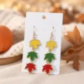 Close-up of autumn gradient maple leaf drop earrings on display card with cozy seasonal background. - Yellow Green Red Gradient Maple Leaf (25080613-2)