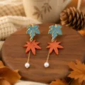Detailed shot of autumn maple leaf pearl dangle earrings with forest style and elegant charm. - Blue And Orange Maple Leaf (25080612-1)