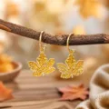 Detailed close-up shot of retro gold-rimmed maple leaf drop earrings with yellow enamel finish. - Yellow (25080609-5)