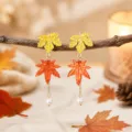 Close-up detail of autumn maple leaf pearl drop earrings with warm forest aesthetic. - Yellow Orange Red Maple Leaf (25080612-5)