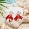 Detail oorbellen koraal zeester parel, strand resort sieraden close-up weergave. - Rood Koraal Strass Zeester Stijl (26062815-3)