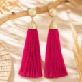 Bohemian fuchsia long tassel earrings with textured gold ball and cone design for resort wear. - Rose Red