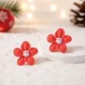 Nahaufnahme roter Blumen-Ohrstecker mit süßem Weihnachtsmann-Zentrum für festlichen Stil. - Roter Weihnachtsmann