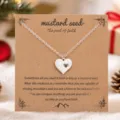 Collier pendentif cœur en acier inoxydable de couleur argentée avec carte cadeau variante. - Pendentif cœur / Or