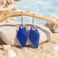 Handmade blue sea glass drop earrings with sterling silver hooks and wire wrap ocean style. - Dark Blue Wire-Wrapped Earrings (24043004)
