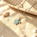 Silver sea turtle pendant necklace with turquoise stone inlay, perfect beach vacation style jewelry. - Necklace