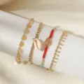 Vierdelige prachtige schelp- en kralenarmbandenset met gouden hartketting en strand sieraden. - Schelp & Hart 4-Delige Armbandset (23121521) / Goud