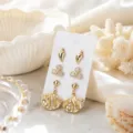 Vue de détail de l'ensemble de boucles d'oreilles coquillage or, style vacances de mer. - Ensemble 9