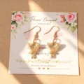 Orecchini con ciondolo bouquet di fiori su cartolina, gioielli da donna alla moda. - Orecchini con carta / oro lucido