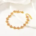 Close-up of luxury gold-plated four-leaf clover crystal bracelet with pink stones. - Four-Leaf Pink Rhinestone