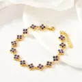 Blue stone clover detail of the gold bracelet, elegant jewelry accessory showcase view. - Four-Leaf Purple Rhinestone