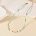 Close-up detail of handmade beaded necklace featuring freshwater pearls and blue glass beads. - Blue Beads