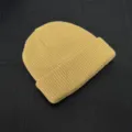 Yellow knitted beanie detail shot, textured wool skull cap close-up, stylish streetwear. - One Size / Turmeric