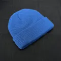Close-up detail of a classic blue knitted beanie, showcasing fine rib knit texture and quality. - One Size / Sapphire Blue
