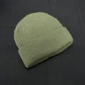Detailed view of the olive green ribbed knit beanie, showing the fine texture and neat fold. - One Size / Army Green