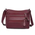Bolso cruzado de cuero suave burdeos con múltiples bolsillos y cremalleras para mujer. - Rojo