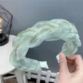 Close-up detail of the light green organza braided rhinestone headband, showing exquisite craftsmanship. - Chain Fruit Green