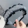 Houndstooth ruffle hair hoop detail view, stylish fabric headband for autumn and winter. - Houndstooth
