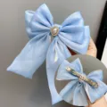 Light blue ribbon bow hair clip with pearl rhinestone center and long tails for women. - Spring Clips / Sky Blue
