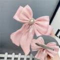 Pink satin bow hair clip with pearl rhinestone center and long ribbons, elegant hair accessory. - Duckbill Hair Clips / Pink