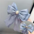 Light blue shiny bow hair clip with pearl rhinestone center and metal spring clip back. - Duckbill Hair Clips / Blue Gray