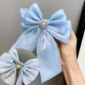 Light blue bow hair clip with pearl rhinestone center, elegant fabric spring barrette. - Brooch Clip / Sky Blue