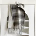 Detailed view of grey and white plaid winter scarf with fringe design showcasing soft fabric texture. - 48x230cm / Gray White Plaid - White Background