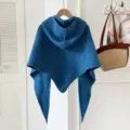 Blue knitted hooded triangular shawl detail showing the soft wool-blend texture and stylish design. - Klein Blue
