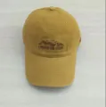 Close-up of the embroidered mountain graphic and text detail on the stylish baseball cap. - Yellow
