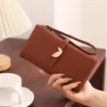 Women's long wallet PU leather portable card holder with leaf buckle and wrist strap. - Brown