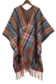 Close-up detail of colorful bohemian knitted poncho cape with fringe and warm plaid pattern. - Colorful Plaid Grey