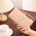 Pink PU leather long wallet detail, elegant leaf metal buckle and wrist strap design. - Pink