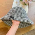 Black and white checkered bucket hat with cute bow detail and brim for women summer sun. - Black