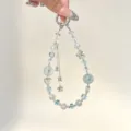 Detailed view of ins-style crystal beaded phone charm with double layer star tassel. - White and Blue