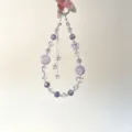 Detail view of the purple crystal beaded phone charm with delicate double layers and cute star tassels. - Muted Purple