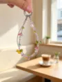 Detailed shot of handmade beaded double chain phone charm with colorful glass mushroom pendants. - Pink Mushroom
