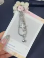 Close-up detail of Y2K star snake bone chain phone charm keychain, stylish metal pendant. - White