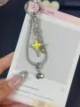 Exquisite detail of Y2K star snake chain keychain with yellow enamel pendant for chic bags. - Yellow