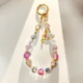 Close-up detail of luxury beaded phone charm with pink crystal beads and alloy butterfly pendant. - Purple Butterfly