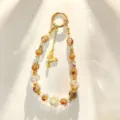 Exquisite crystal beaded phone chain detail, luxury gold butterfly charm and gold foil beads. - Pink Butterfly