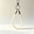Detailed close-up of colorful TPU telephone cord wrist lanyard featuring durable metal clasps. - Yellow Musical Note