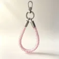 Close-up detail of the pink telephone cord phone strap with silver metal clasp and connectors. - Pink Leopard