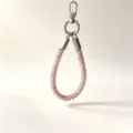 Detail view of rose gold telephone wire phone wrist lanyard close up clasp texture. - Brown Leopard