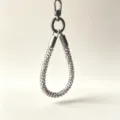 Close-up detail of the leopard print beaded phone lanyard with metallic hardware and clasp. - White Leopard Print