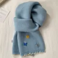 Lichtblauwe gebreide sjaal met geborduurde vlinders en contrasterende golfrand, lekker warm. - Blauw Vlinder Breisel