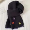 Black knitted scarf featuring colorful embroidered butterflies and stylish purple scalloped edge design. - Black Butterfly Knit