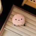 Close-up detail shot of a cute pink plush animal hair clip displayed on a soft beige tray. - Small Animal Hair Clip / Pink