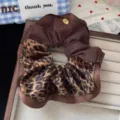 Brown leopard print scrunchie detail view, showing soft fabric texture and fashionable design style. - Leopard Print