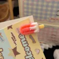 Close-up shot of a cute ice cream hair clip detail, showing frosted texture and sweet candy colors. - Red Ice Cream Hair Clip